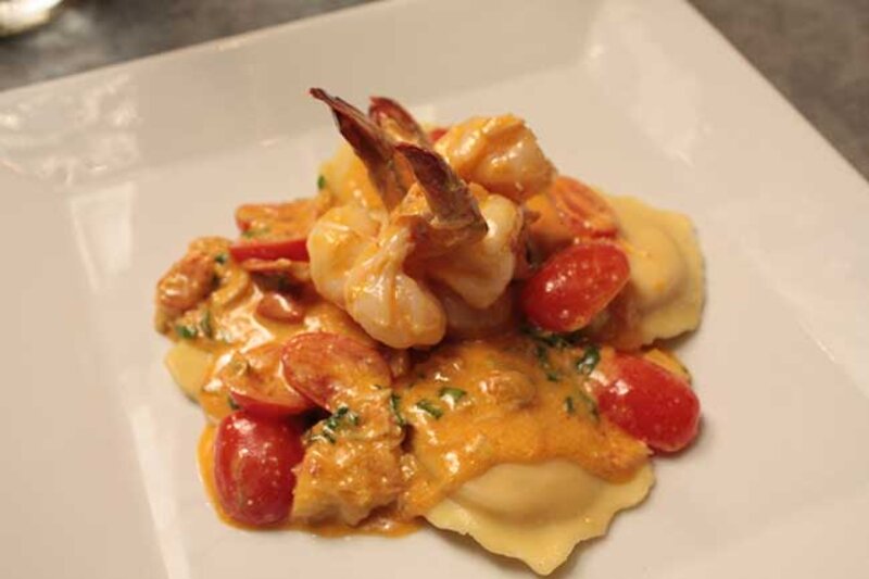 Ravioli topped with shrimp and peppers